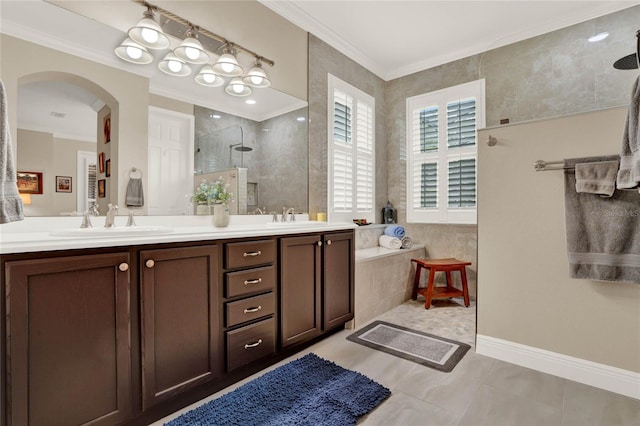 bathroom featuring a tile shower, tile patterned flooring, vanity, and crown molding