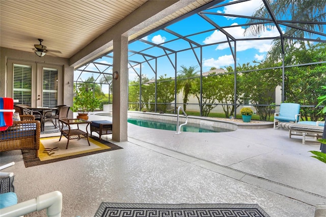 view of pool featuring a lanai, ceiling fan, and a patio area