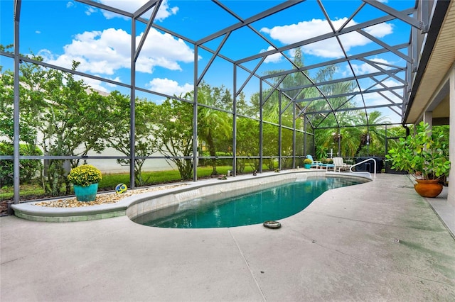 view of pool featuring glass enclosure and a patio area