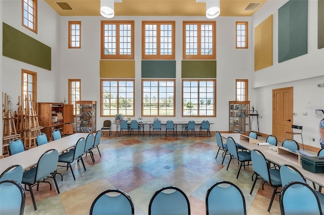 dining room featuring a towering ceiling