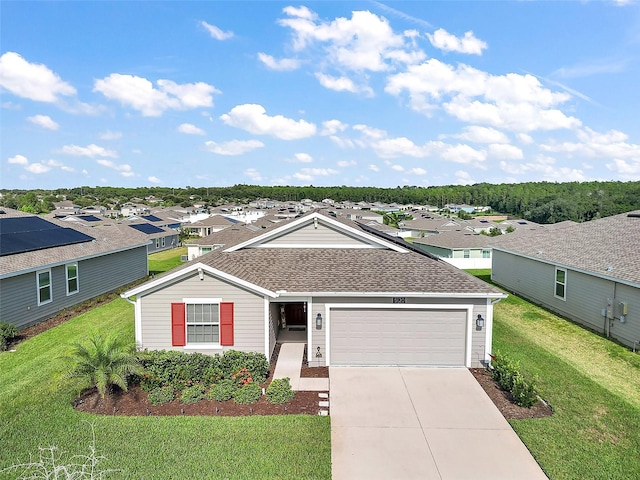 single story home featuring a front yard and a garage