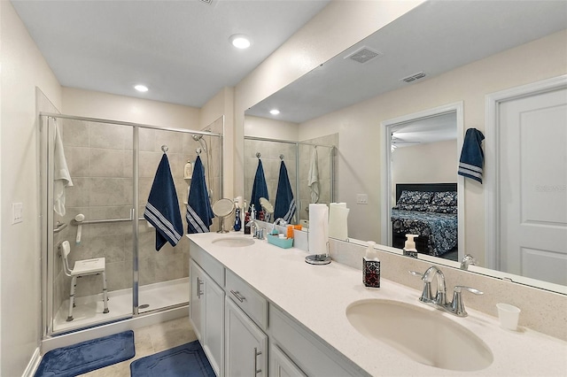 bathroom featuring vanity, ceiling fan, and an enclosed shower