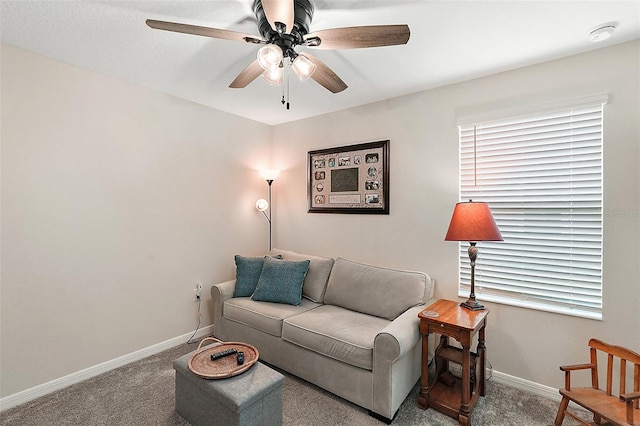 living room with ceiling fan, carpet flooring, and baseboards