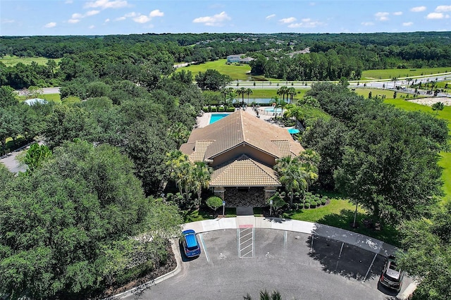 birds eye view of property featuring a view of trees