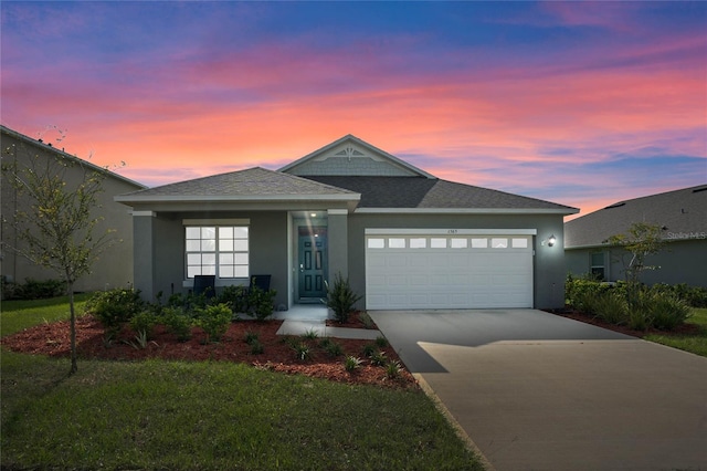 view of front facade with a yard and a garage