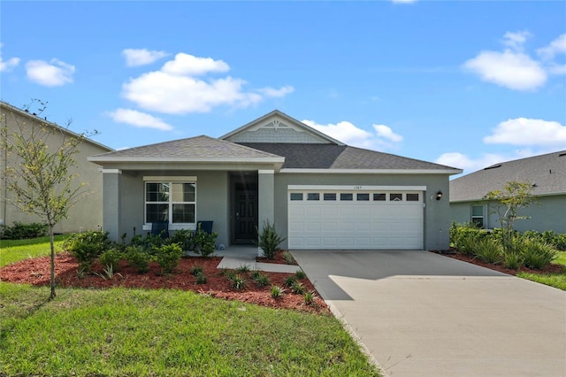 view of front of home with a garage and a front lawn