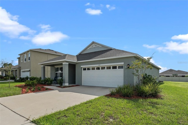 view of front of property featuring a garage and a front lawn