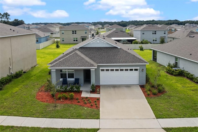 view of front of property with a front yard and a garage