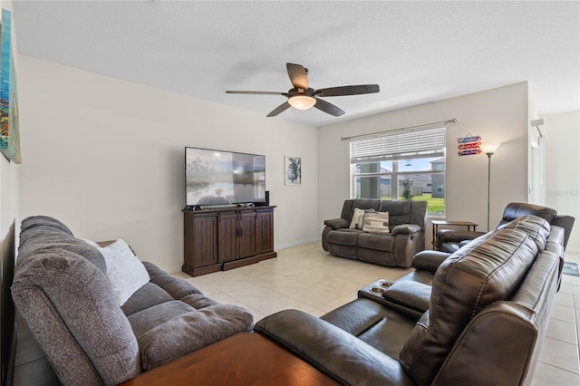 tiled living room with a textured ceiling and ceiling fan