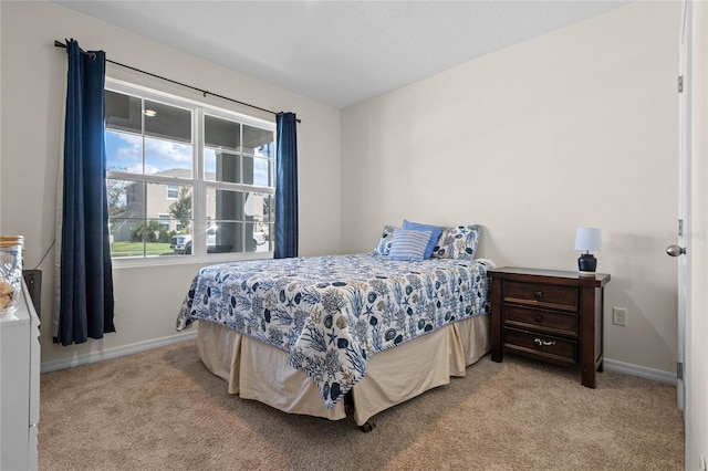 bedroom with light colored carpet