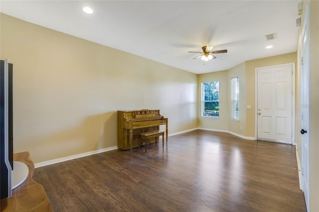 interior space featuring ceiling fan and dark wood-type flooring