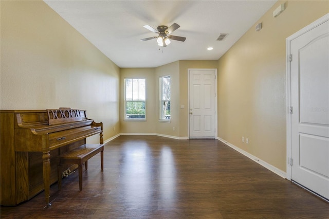 miscellaneous room with ceiling fan and dark wood-type flooring