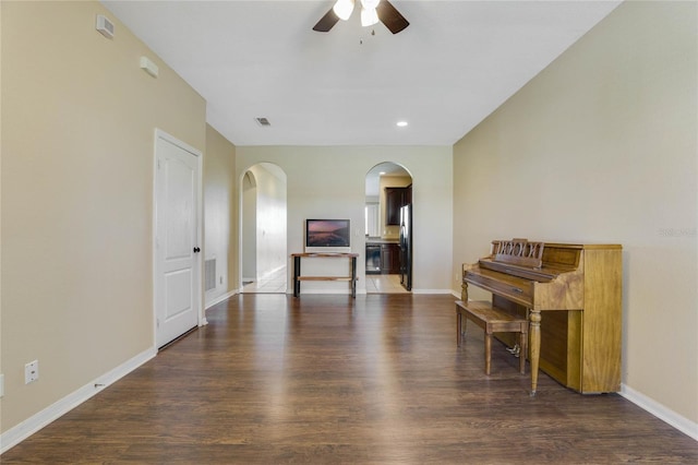 interior space with dark hardwood / wood-style flooring and ceiling fan