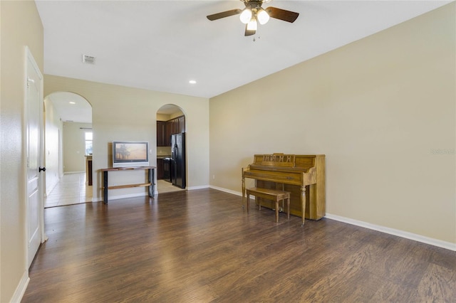 unfurnished room with ceiling fan and dark wood-type flooring