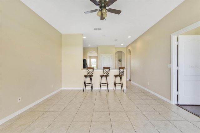 unfurnished dining area featuring ceiling fan and light tile patterned flooring