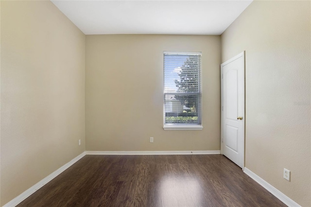 spare room featuring dark hardwood / wood-style flooring