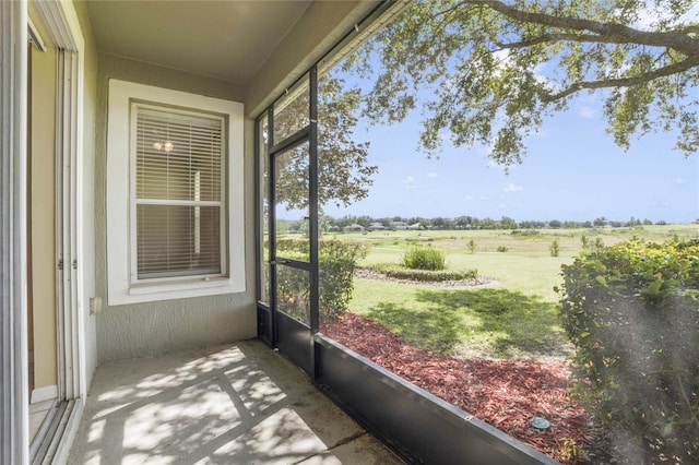 unfurnished sunroom featuring a rural view