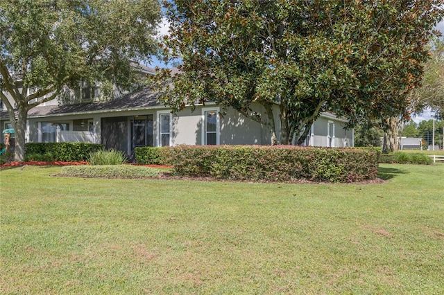 obstructed view of property featuring a front yard