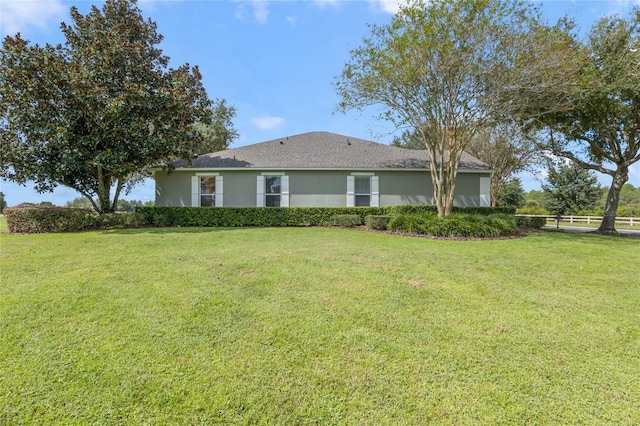 rear view of house featuring a lawn