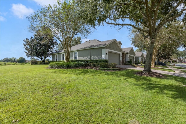 view of home's exterior with a yard and a garage