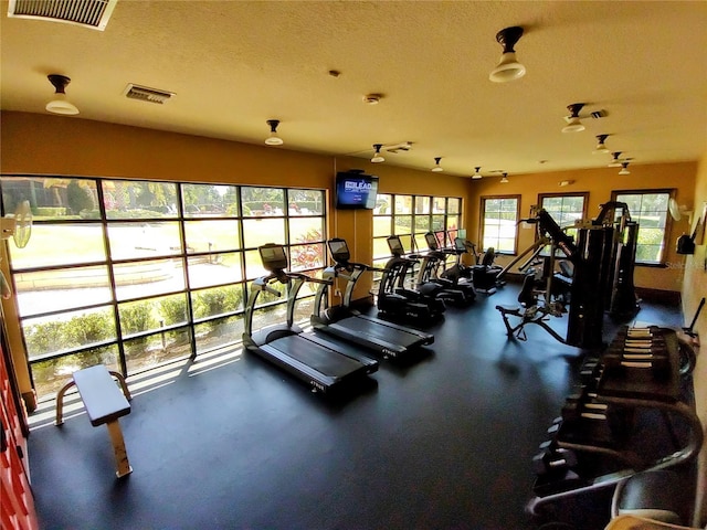 workout area with a textured ceiling