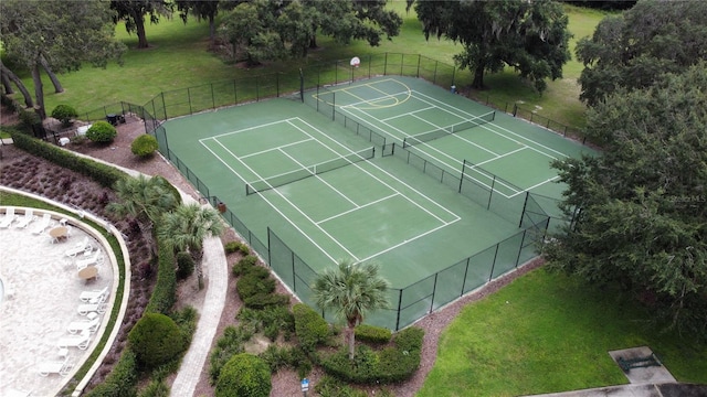 view of tennis court featuring a yard and basketball court