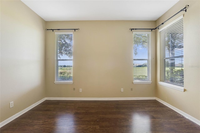 unfurnished room with dark hardwood / wood-style floors