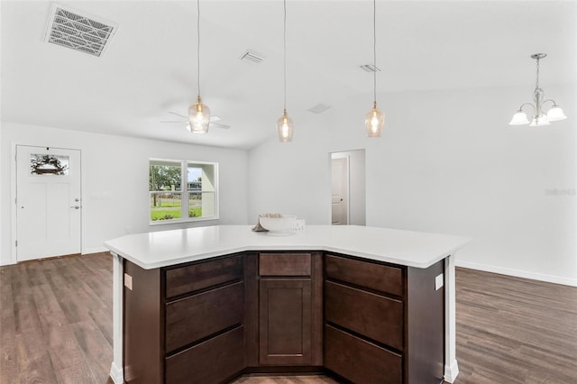 kitchen featuring lofted ceiling, hardwood / wood-style flooring, ceiling fan with notable chandelier, and a kitchen island