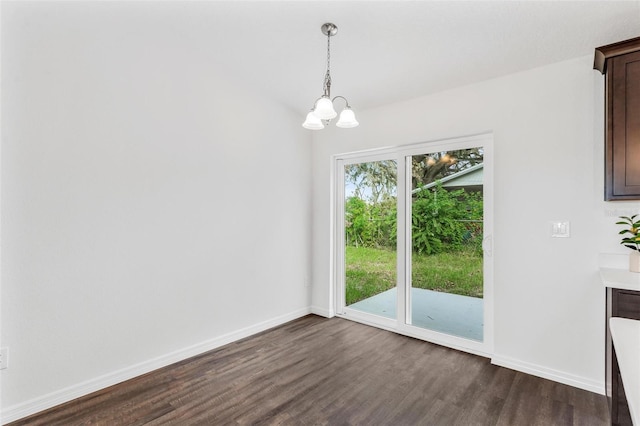 unfurnished dining area with a chandelier and dark wood-type flooring