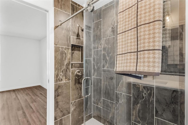 bathroom with walk in shower and hardwood / wood-style flooring