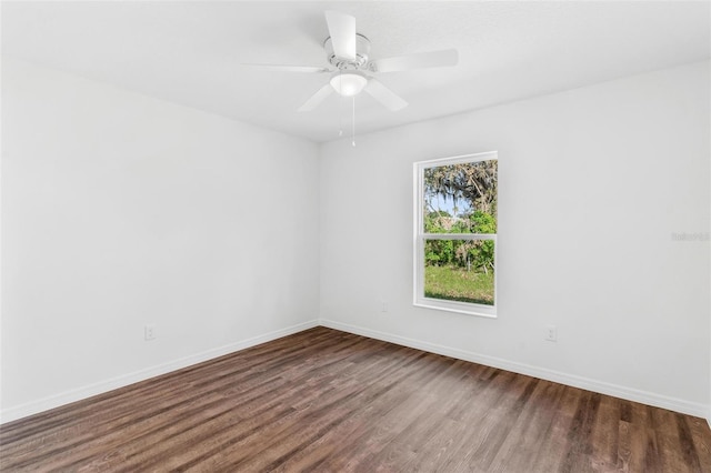 unfurnished room with dark hardwood / wood-style floors and ceiling fan