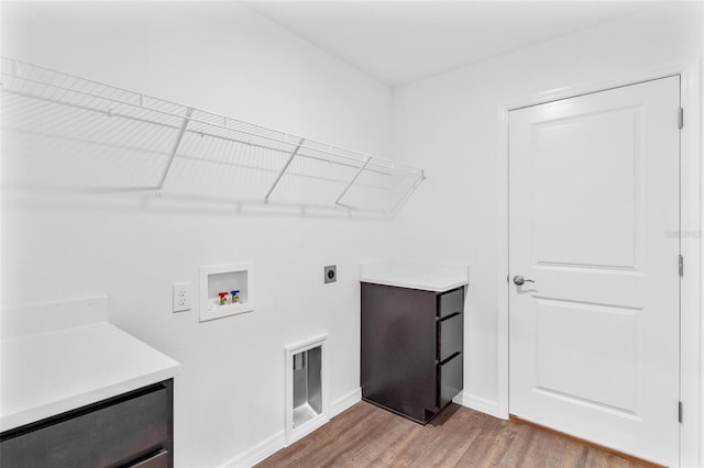 laundry area with hookup for an electric dryer, hardwood / wood-style flooring, and washer hookup