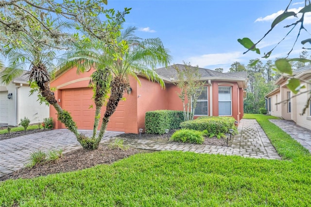 view of front facade with a front yard and a garage