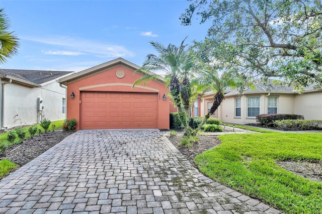 single story home with a garage and a front yard