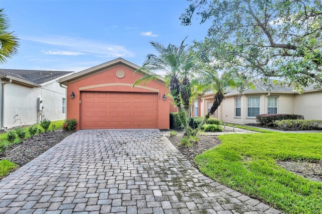 540 Grand Canal Dr, Kissimmee, FL 34759 - view of front of home with decorative driveway, an attached garage, and stucco siding