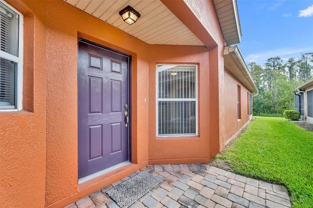 entrance to property with a yard