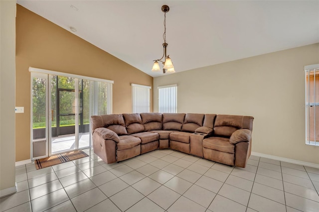 tiled living room with an inviting chandelier, high vaulted ceiling, and plenty of natural light