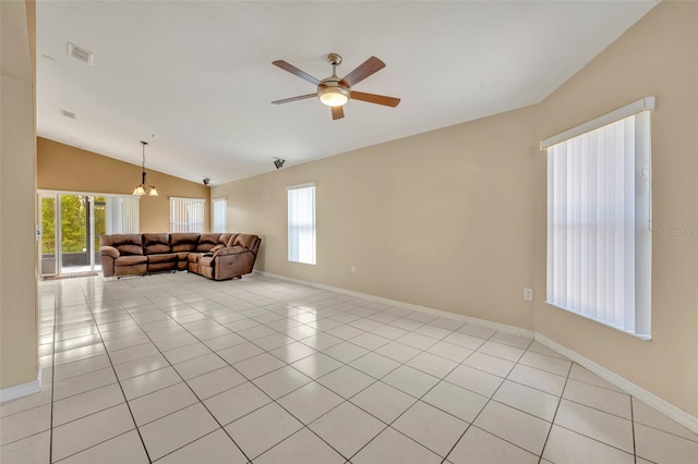 tiled living room with ceiling fan with notable chandelier and lofted ceiling