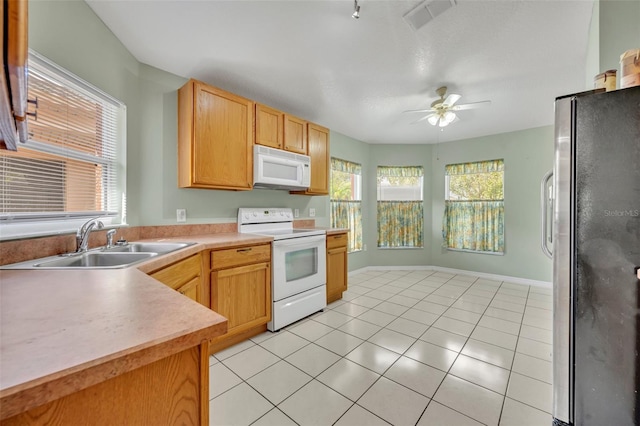 kitchen with white appliances, ceiling fan, light tile patterned flooring, and sink