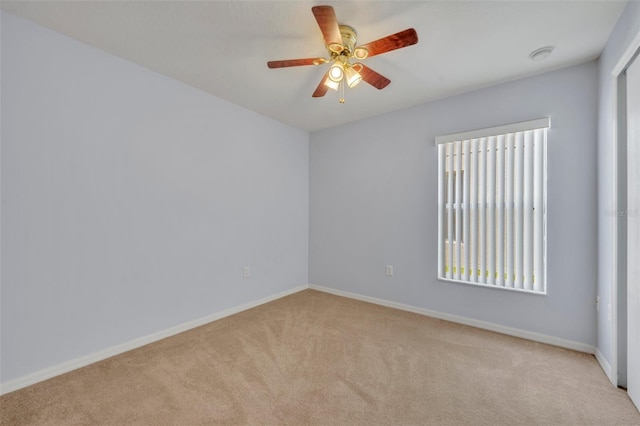 carpeted spare room with ceiling fan