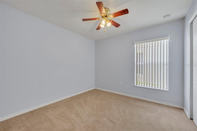 540 Grand Canal Dr, Kissimmee, FL 34759 - carpeted spare room featuring baseboards, ceiling fan, and a healthy amount of sunlight