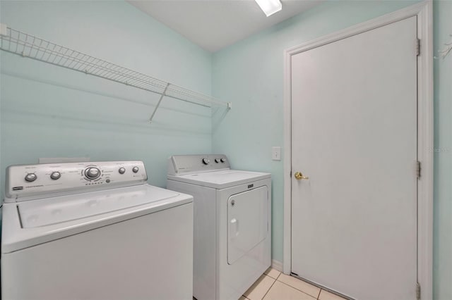 washroom with light tile patterned flooring and washer and clothes dryer