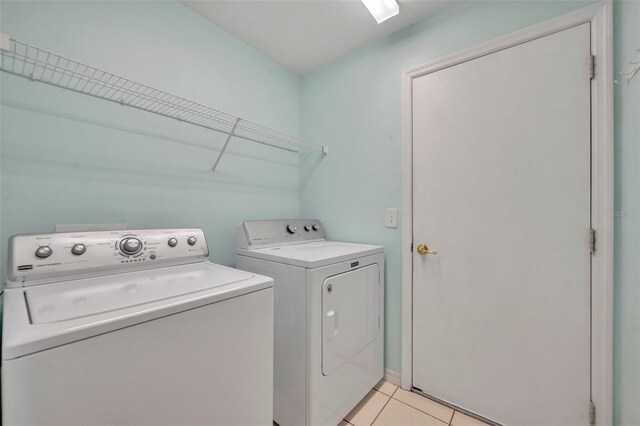 540 Grand Canal Dr, Kissimmee, FL 34759 - clothes washing area featuring separate washer and dryer, laundry area, and light tile patterned floors
