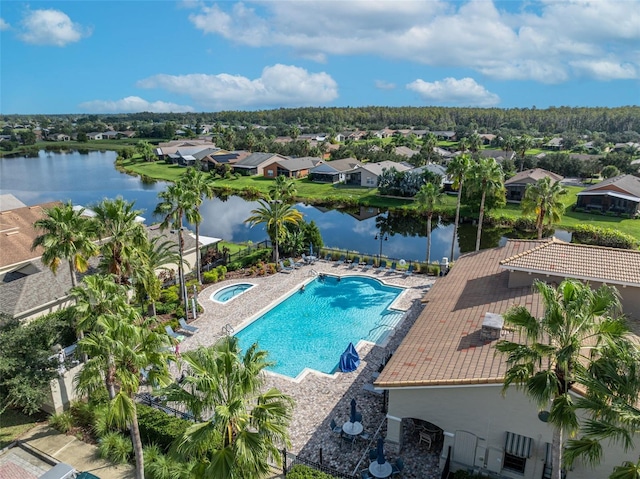 view of pool with a water view and a patio