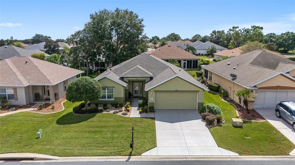 view of front of property featuring a garage and a front lawn