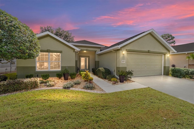 single story home featuring a lawn and a garage