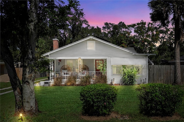 view of front facade featuring a yard and covered porch