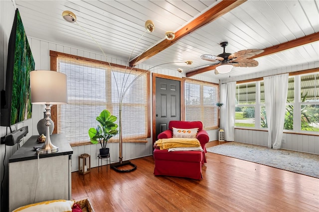 sunroom / solarium with ceiling fan, beamed ceiling, and wooden ceiling