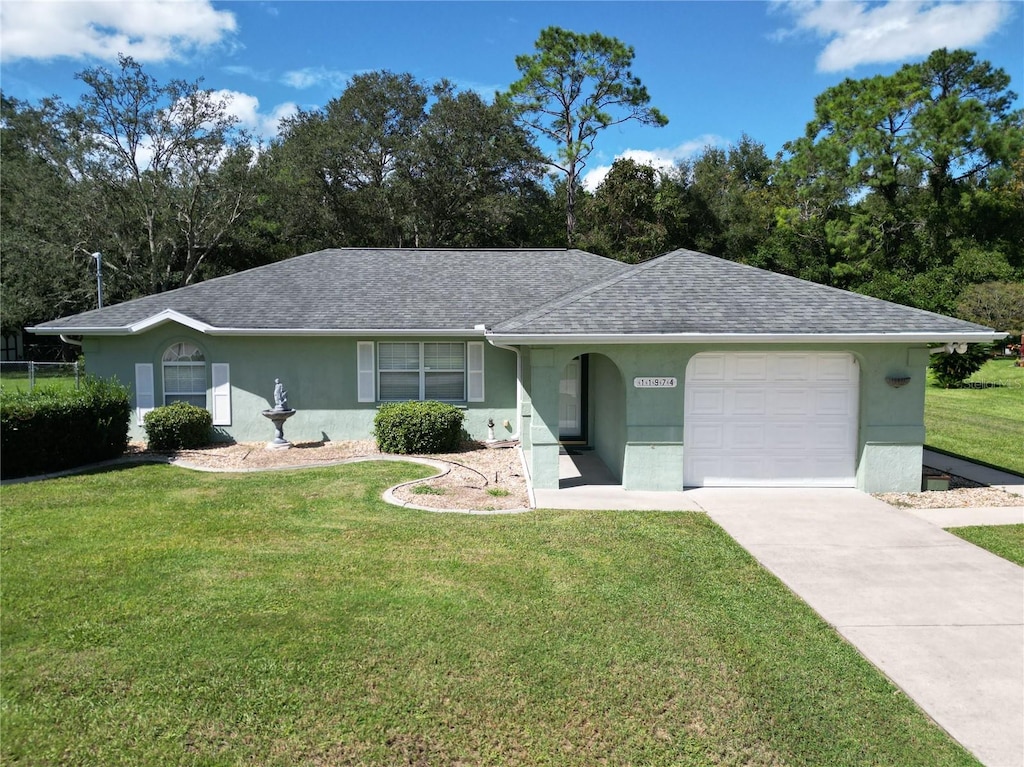 ranch-style house featuring a front yard and a garage