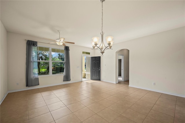 tiled spare room with ceiling fan with notable chandelier